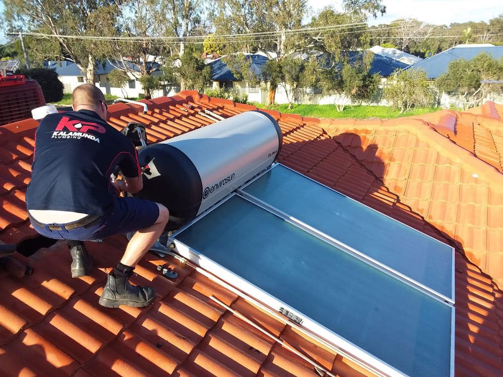 kp plumber on roof installing solar 1 1